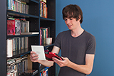Young man holding an item while viewing it with the RUBY 7 HD